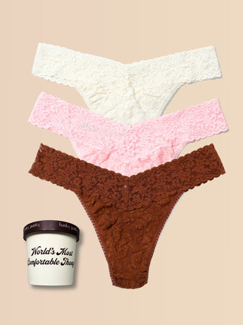 Three pairs of lace thongs in white, pink, and brown on a beige background with a container labeled 'World's Most Comfortable Thong'.