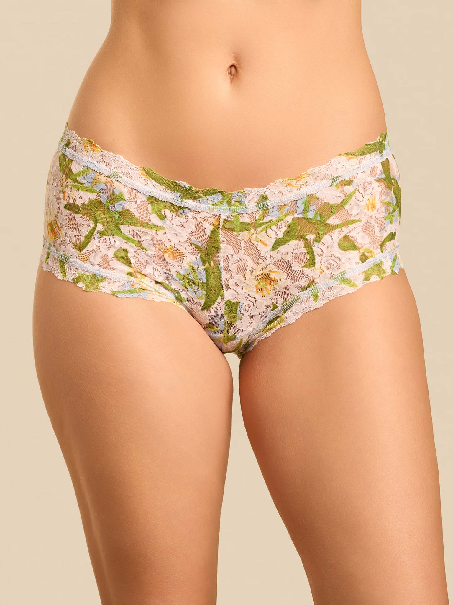 Floral-patterned underwear worn by a person on a beige background