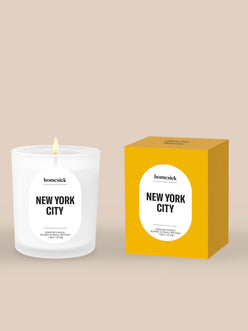 Homesick New York City mini candle and packaging on a beige background. Free gift when you spend $100.