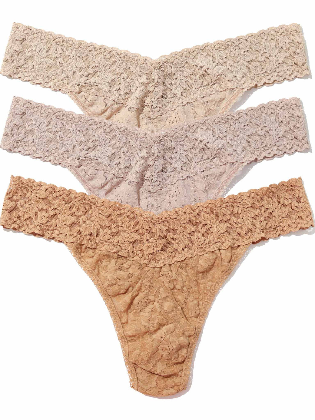 Thre pairs of lace thongs in chai, taupe and suntan on a white background