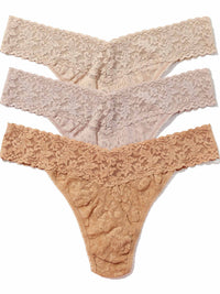 Thre pairs of lace thongs in chai, taupe and suntan on a white background