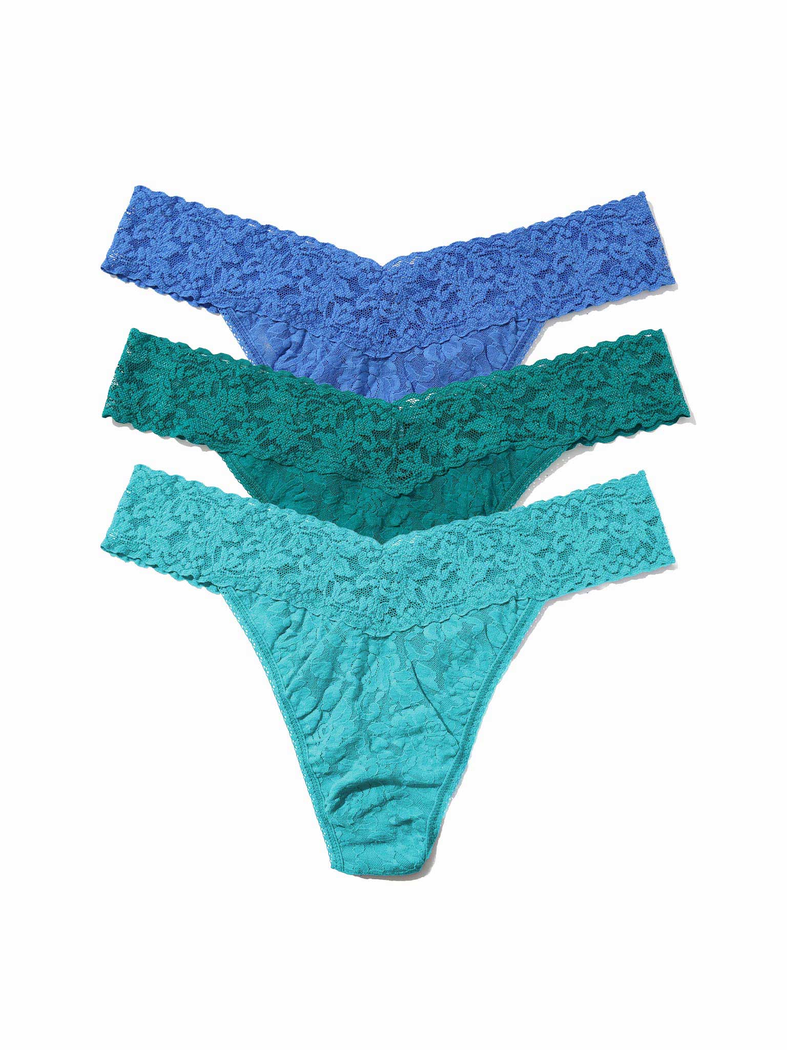 Three pairs of lace thongs in blue and green on a white background