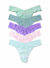 Set of four pairs of pastel-colored lace underwear on a white background