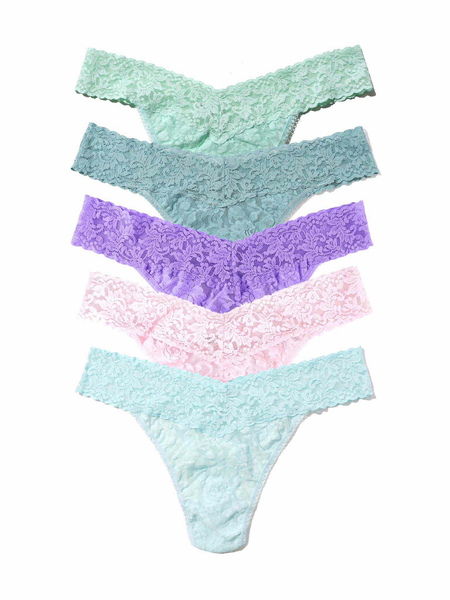 Set of four pairs of pastel-colored lace underwear on a white background