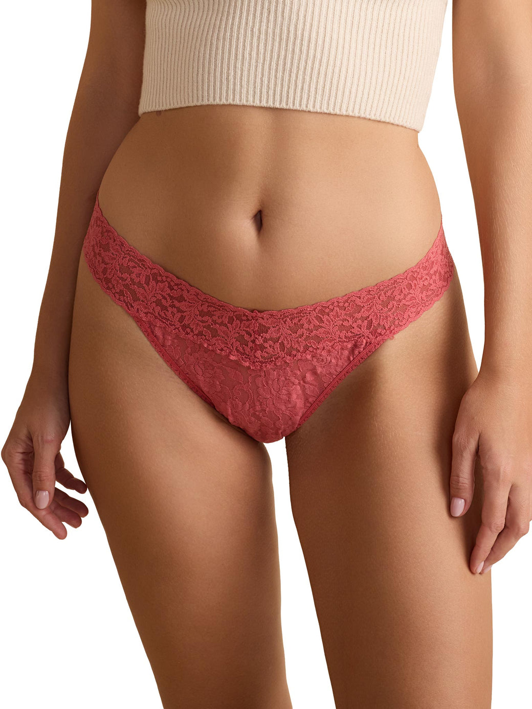 Red lace underwear worn by a person on a white background