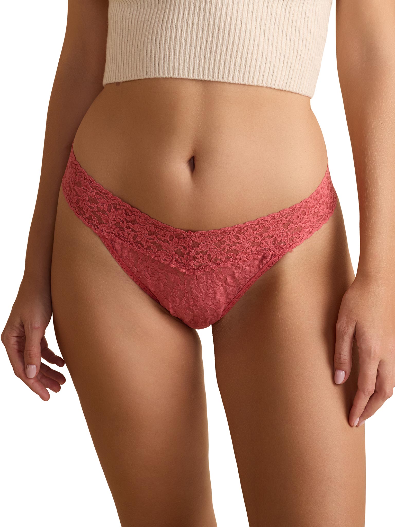 Red lace underwear worn by a person on a white background