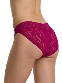 Close-up of a person wearing a pink lace underwear on a white background