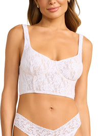 Woman wearing a white lace bra and panties set on a white background