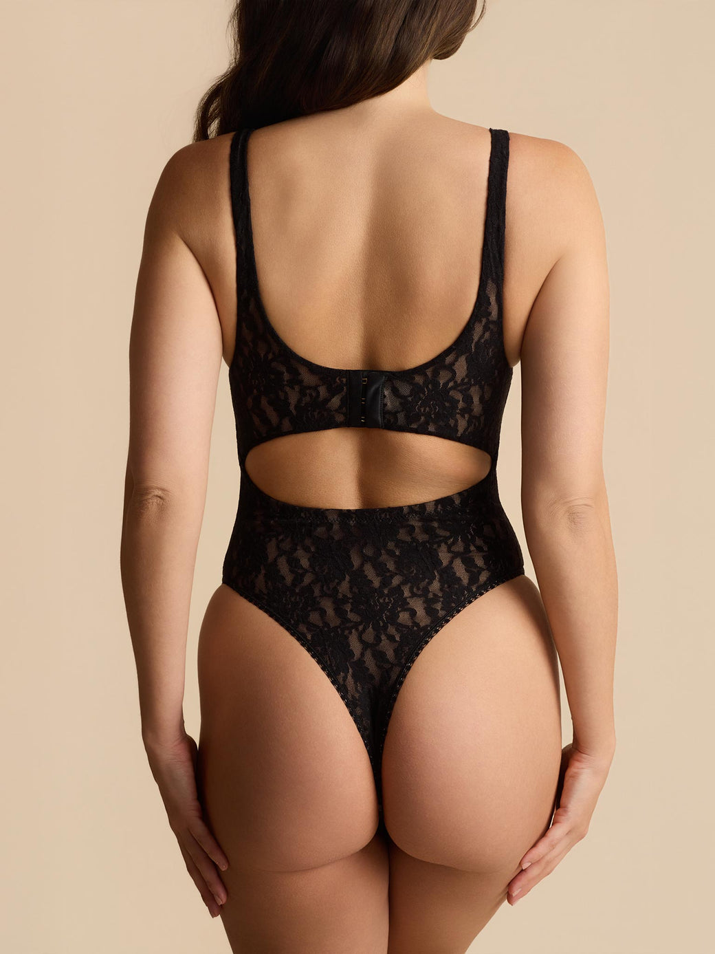 Black lace lingerie set on a beige background