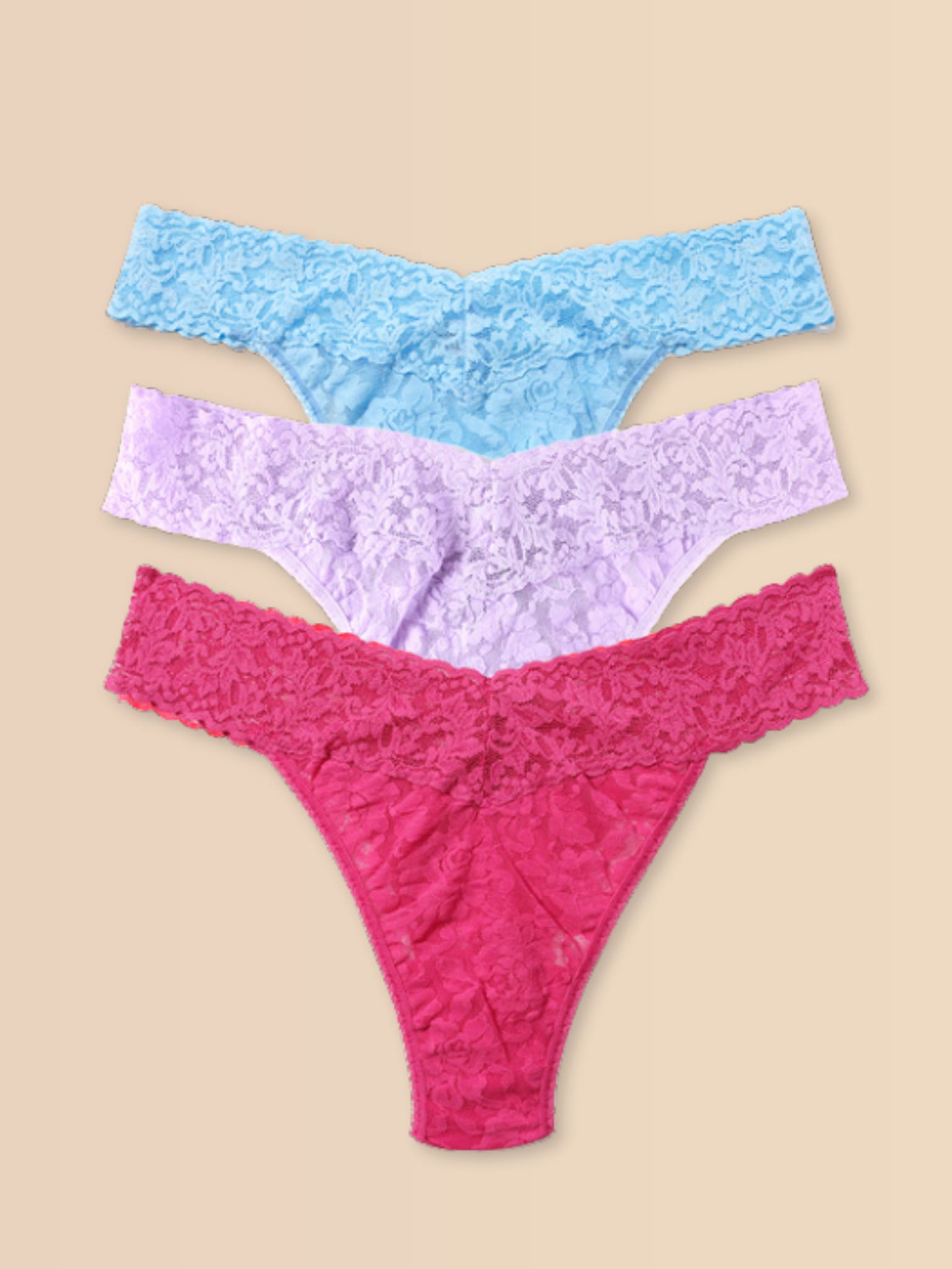 Signature Lace® Original Rise Thong 3-Pack Pastel Punch - Blue, Lavender & Pink Flat Lay on Warm Cream Backdrop | Hanky Panky