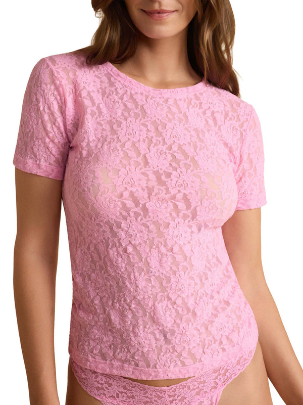 Pink lace top worn by a model on a white background