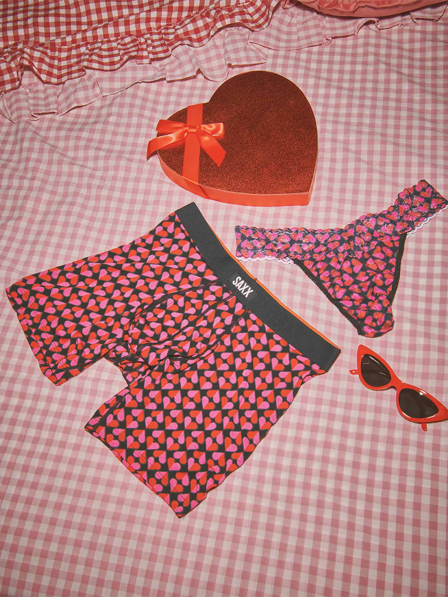 Hanky Panky x SAXX Love Check Black heart-print lace thong and boxer brief matching set - Valentine's Day flat lay | Hanky Panky