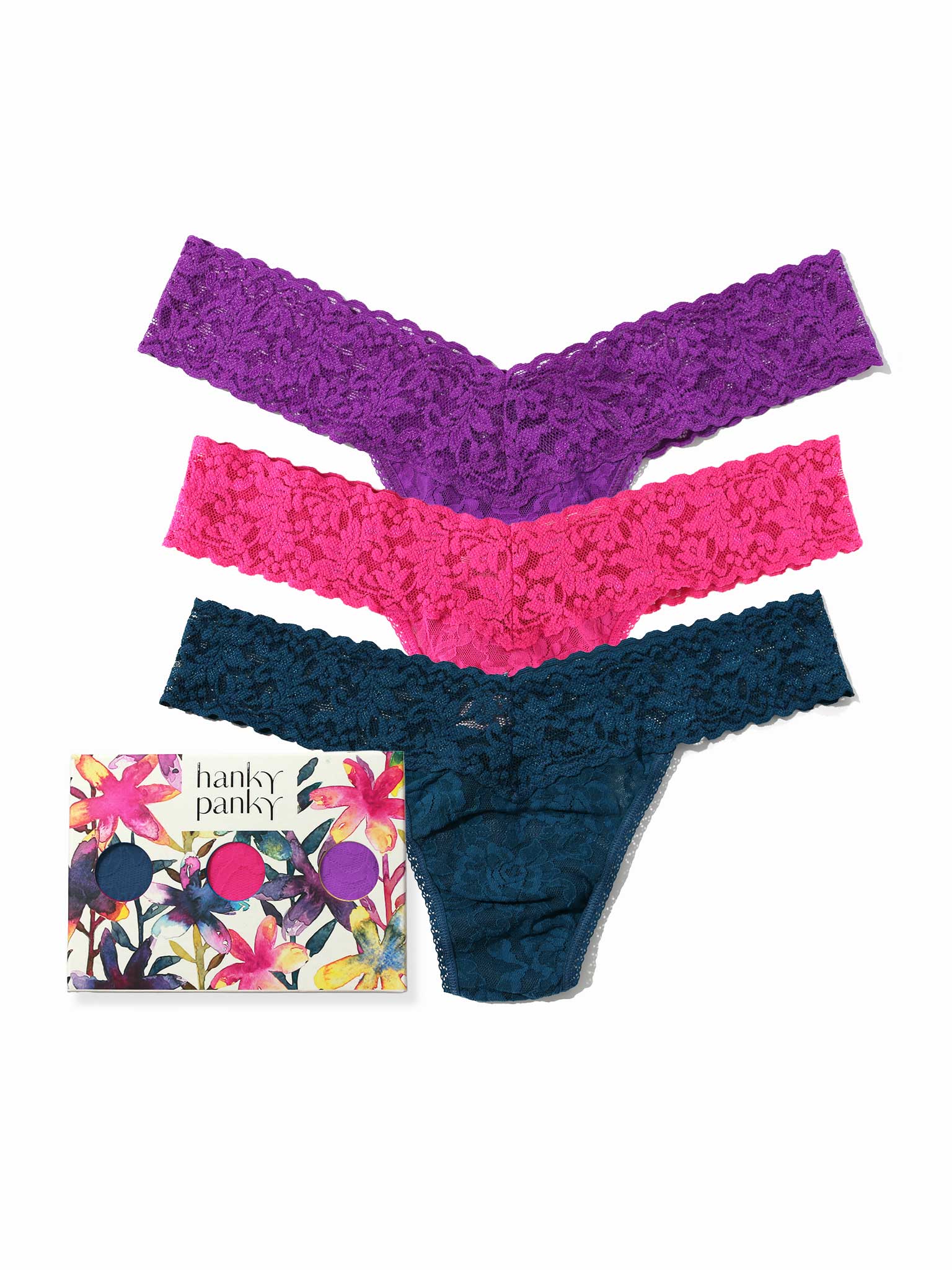 Three pairs of lace underwear in purple, pink, and blue with a floral-patterned box labeled 'hanky pankys' on a white background.
