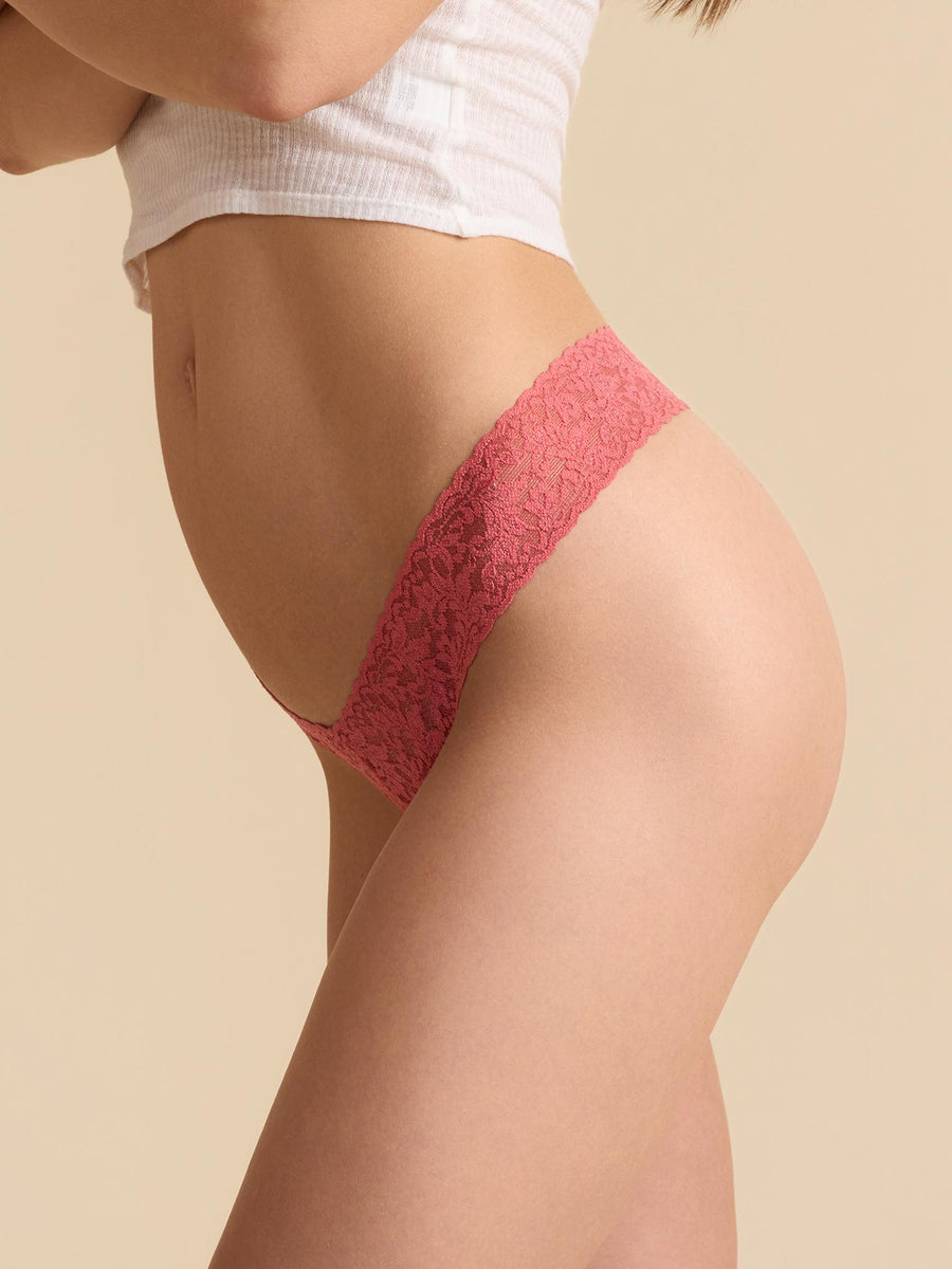 Naples Red Signature Lace® Low Rise Thong - Side Profile On Model, No-Dig Lace Waistband Detail, Beige Background | Hanky Panky