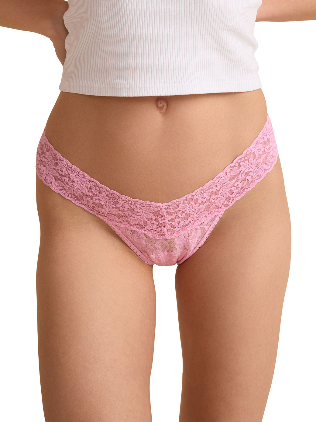 Pink lace thong worn by a person on a white background
