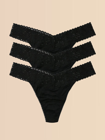 Black DreamEase™ Original Rise Thong 3-Pack, Flat Lay on Cream | Hanky Panky
