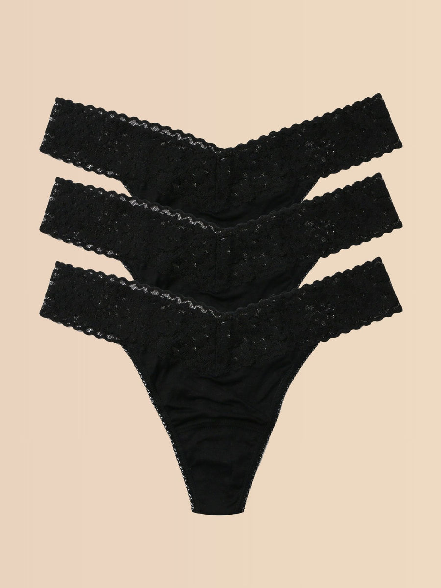 Black DreamEase™ Original Rise Thong 3-Pack, Flat Lay on Cream | Hanky Panky