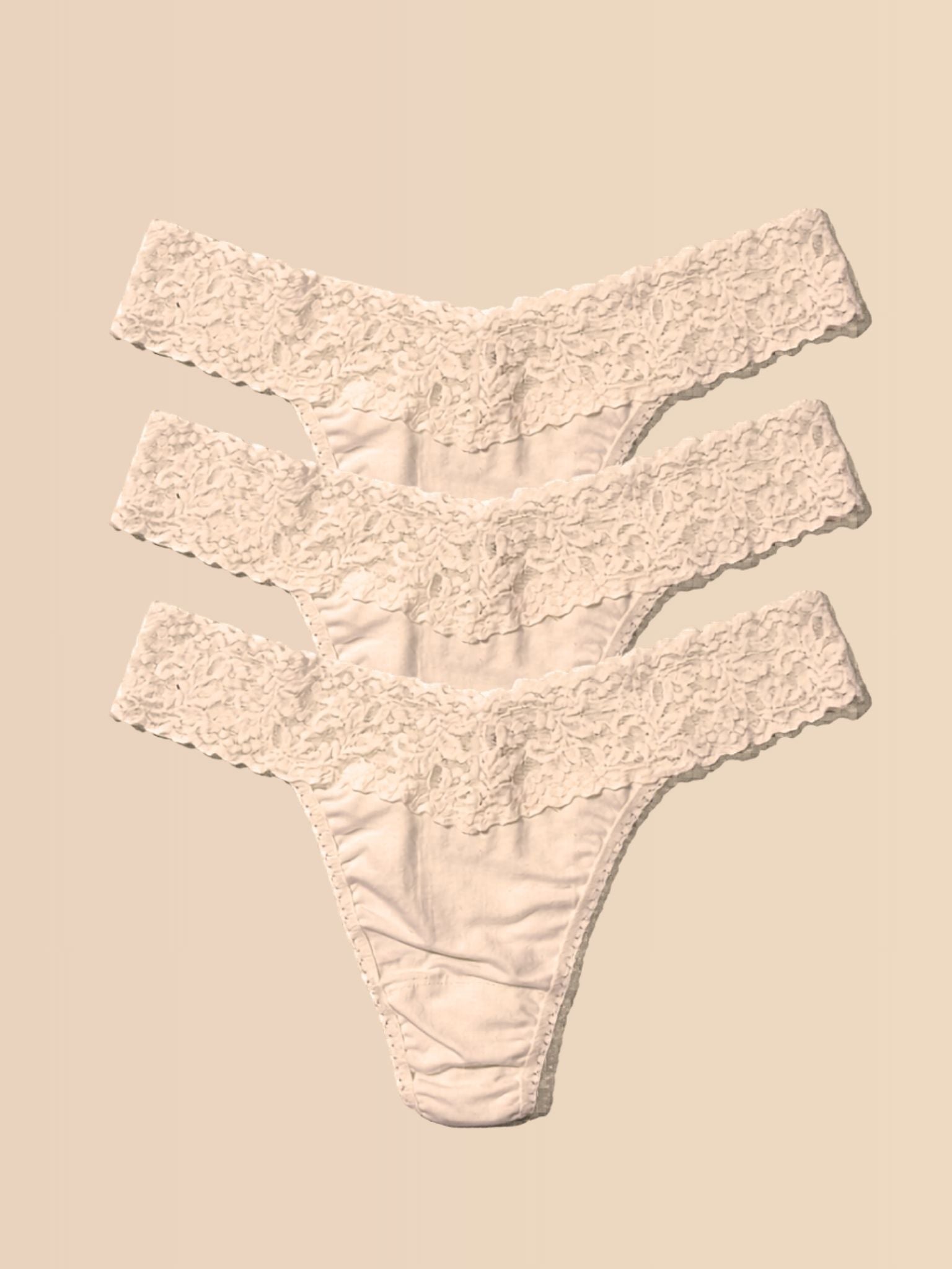 Chai DreamEase™ Soft Lace Thong 3-Pack - Flat Lay on Cream | Hanky Panky