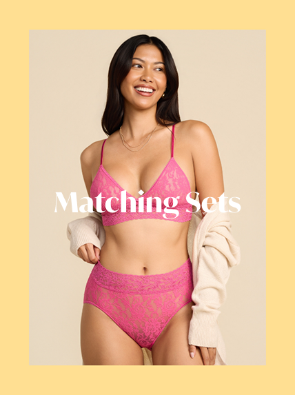 Woman wearing a pink lingerie set with text 'Matching Sets' on a beige background