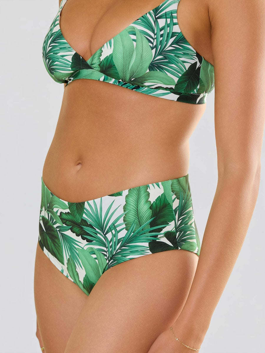Model facing front wearingSwim High Rise Bottom Stay Floral Palm Tree Green with matching top 