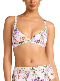 Woman wearing a floral bikini set on a white background