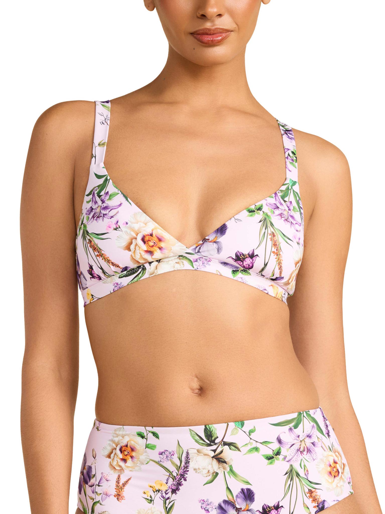 Woman wearing a floral bikini set on a white background