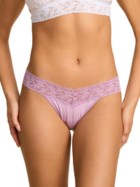 Lace underwear with a white lace top on a plain background