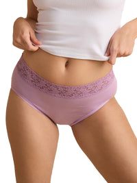 Purple lace-trimmed underwear worn with a white top on a plain background