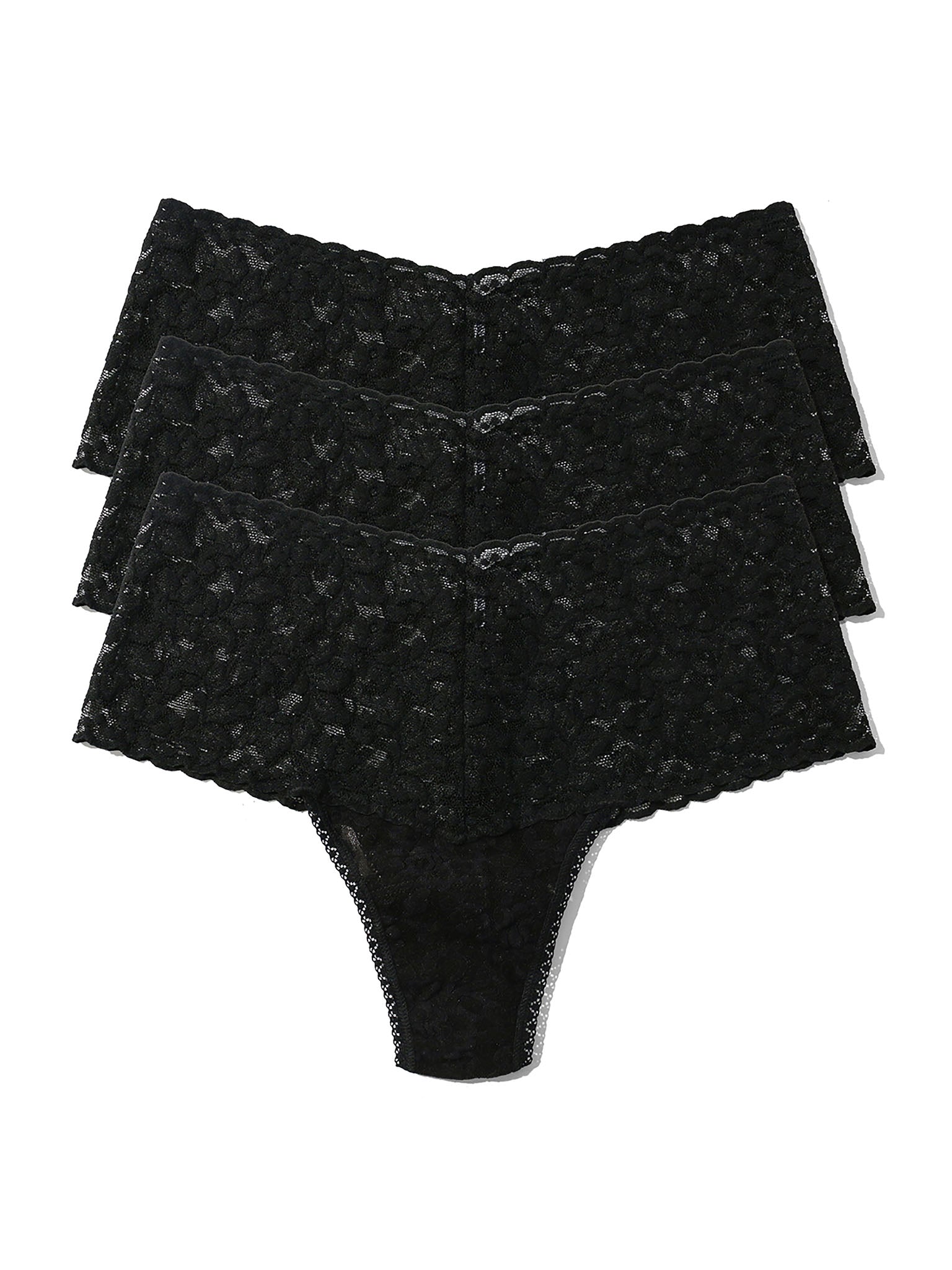 Three pairs of black lace underwear stacked on a white background