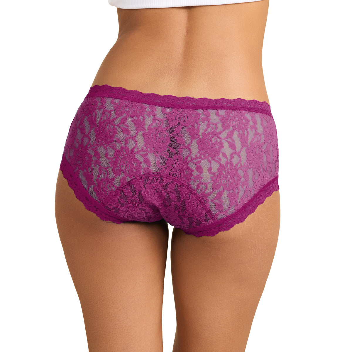 A close-up rear view of a model wearing bright magenta lace panties against a plain white background.