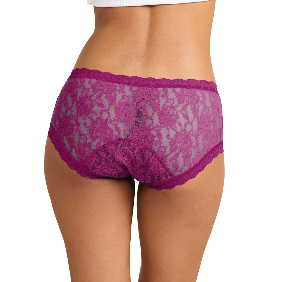 A close-up rear view of a model wearing bright magenta lace panties against a plain white background.