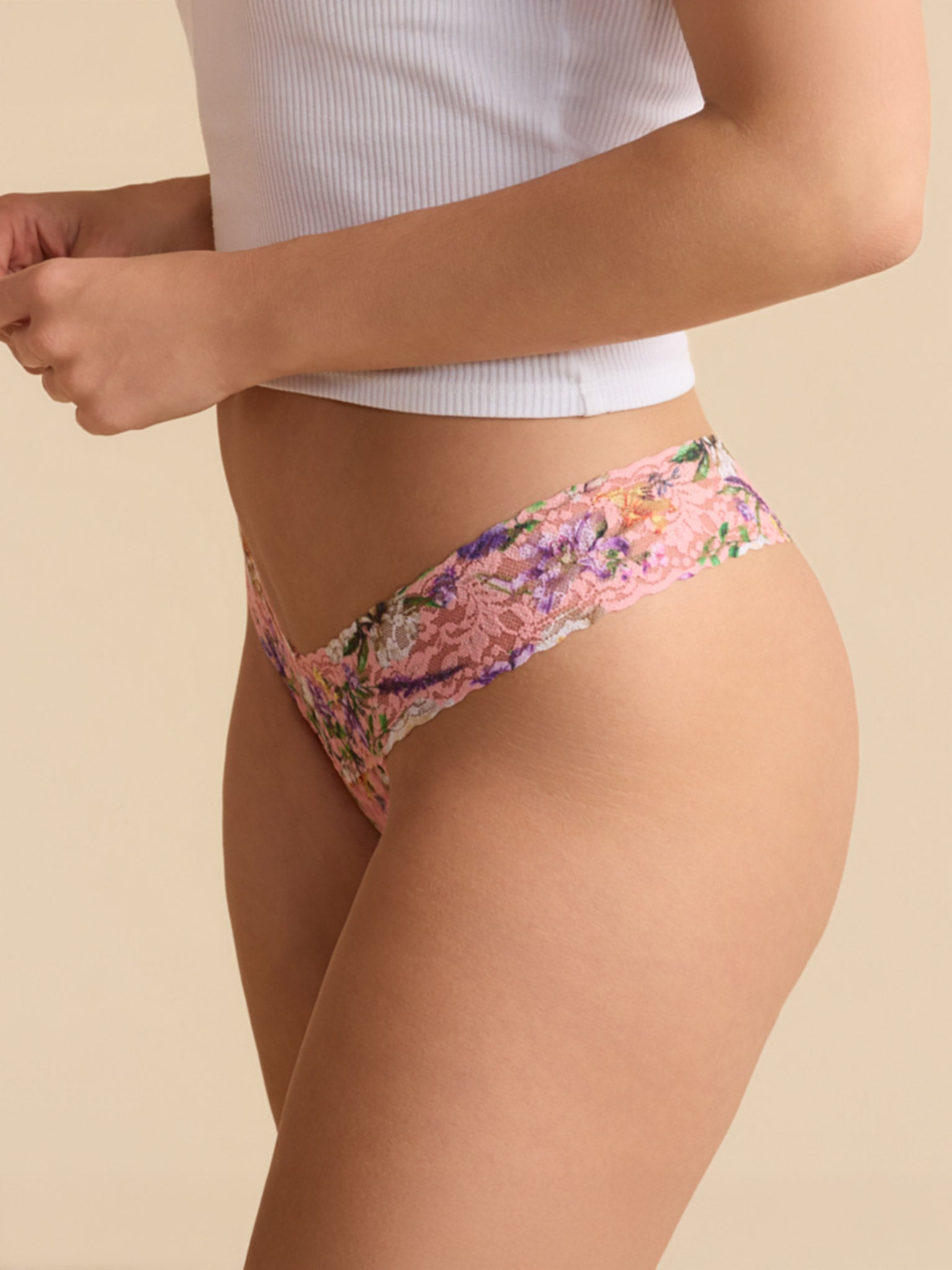 Model in white ribbed top wearing Printed Signature Lace® Low Rise Thong Fawning Flora Coral - Side Profile, floral lace thong | Hanky Panky