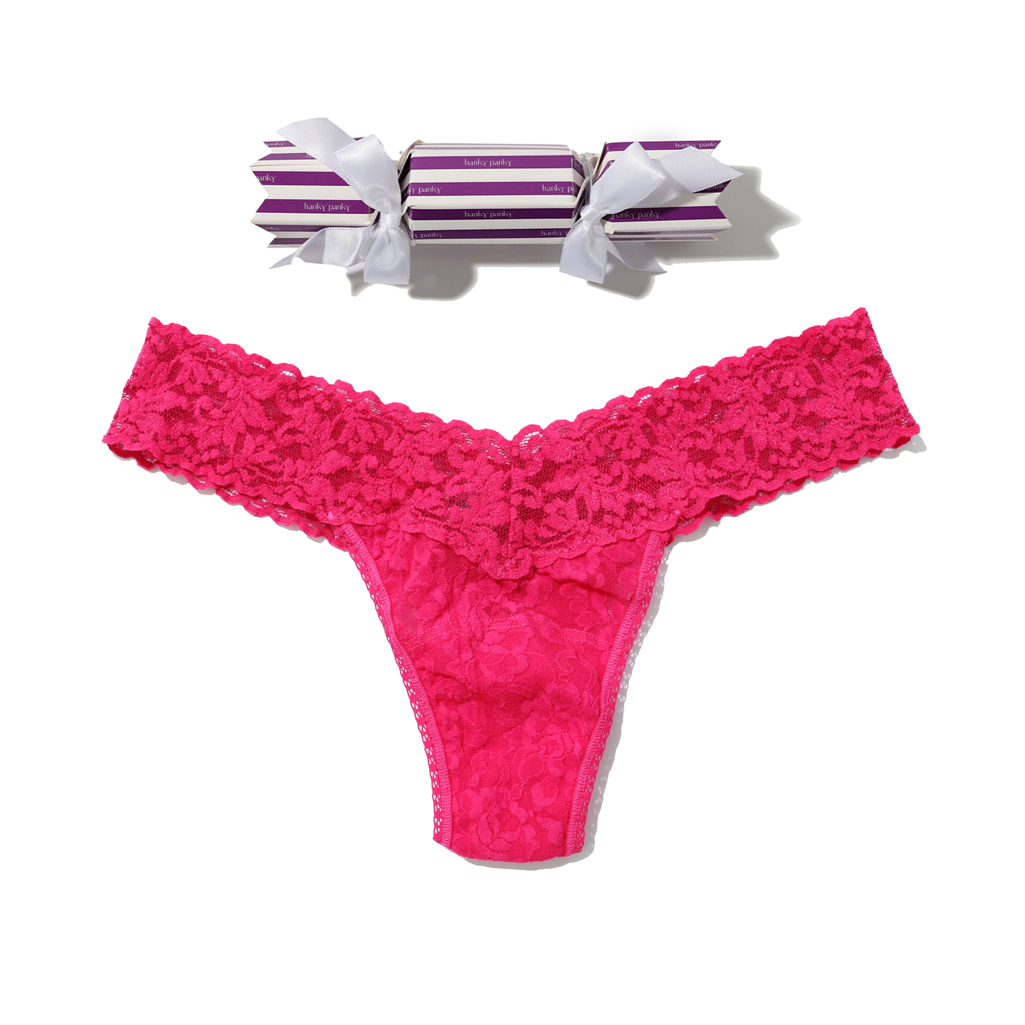 Pink lace thong with striped candy on a white background