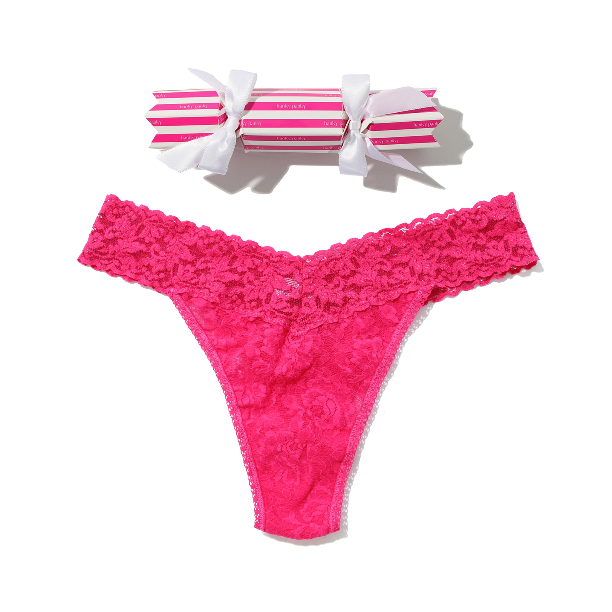 Pink lace thong with a striped box on a white background