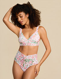 Woman wearing a floral bikini set against a beige background