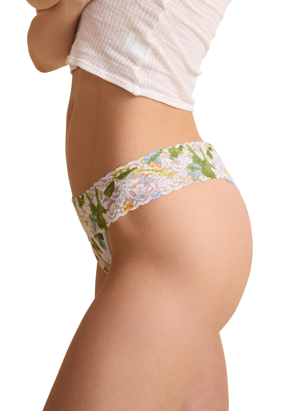 Floral lace underwear worn by a person on a white background
