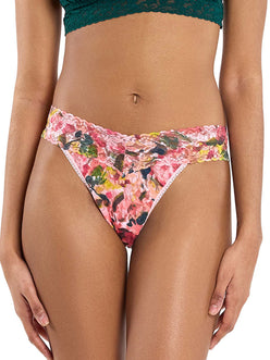woman wearing floral pink lace thong standing in front of white background