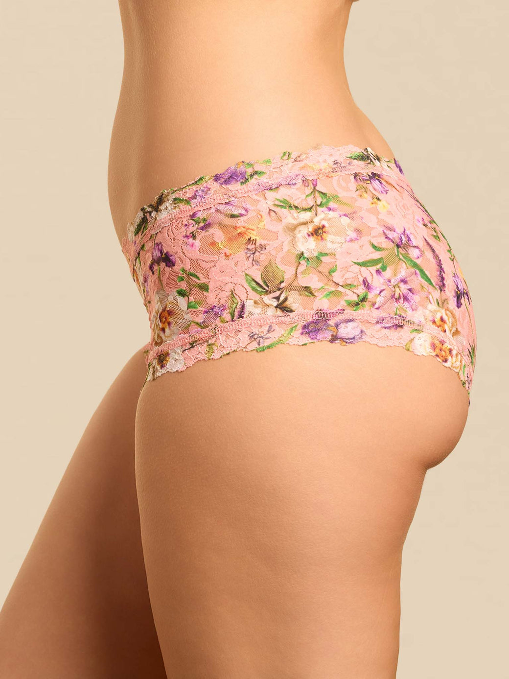 Floral-patterned high-waisted bikini bottom on a beige background