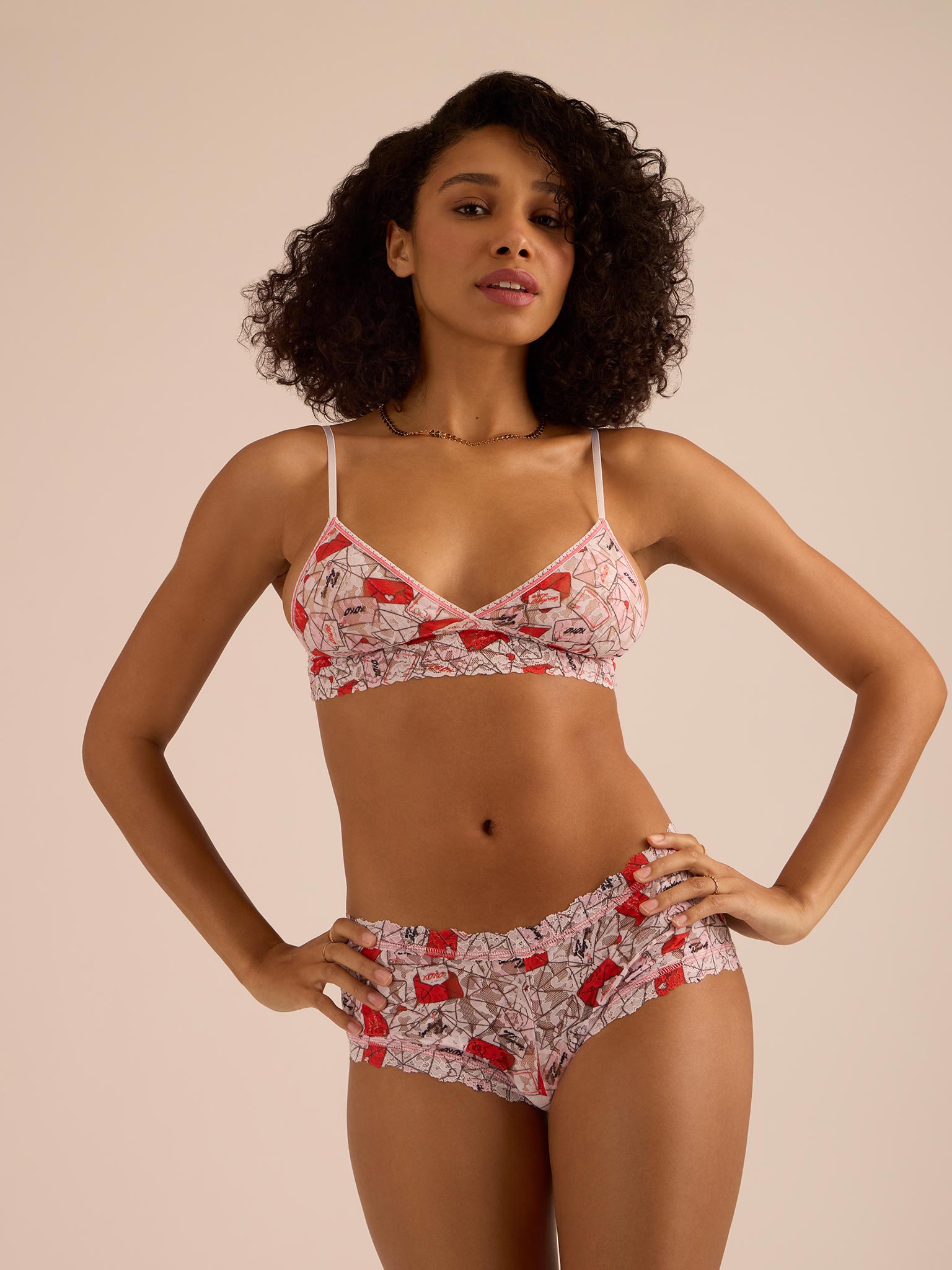 Woman wearing a patterned bikini set against a beige background