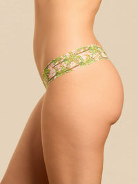 Green floral lace underwear on a beige background