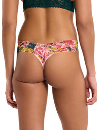 woman wearing floral pink lace thong facing backwards on white background