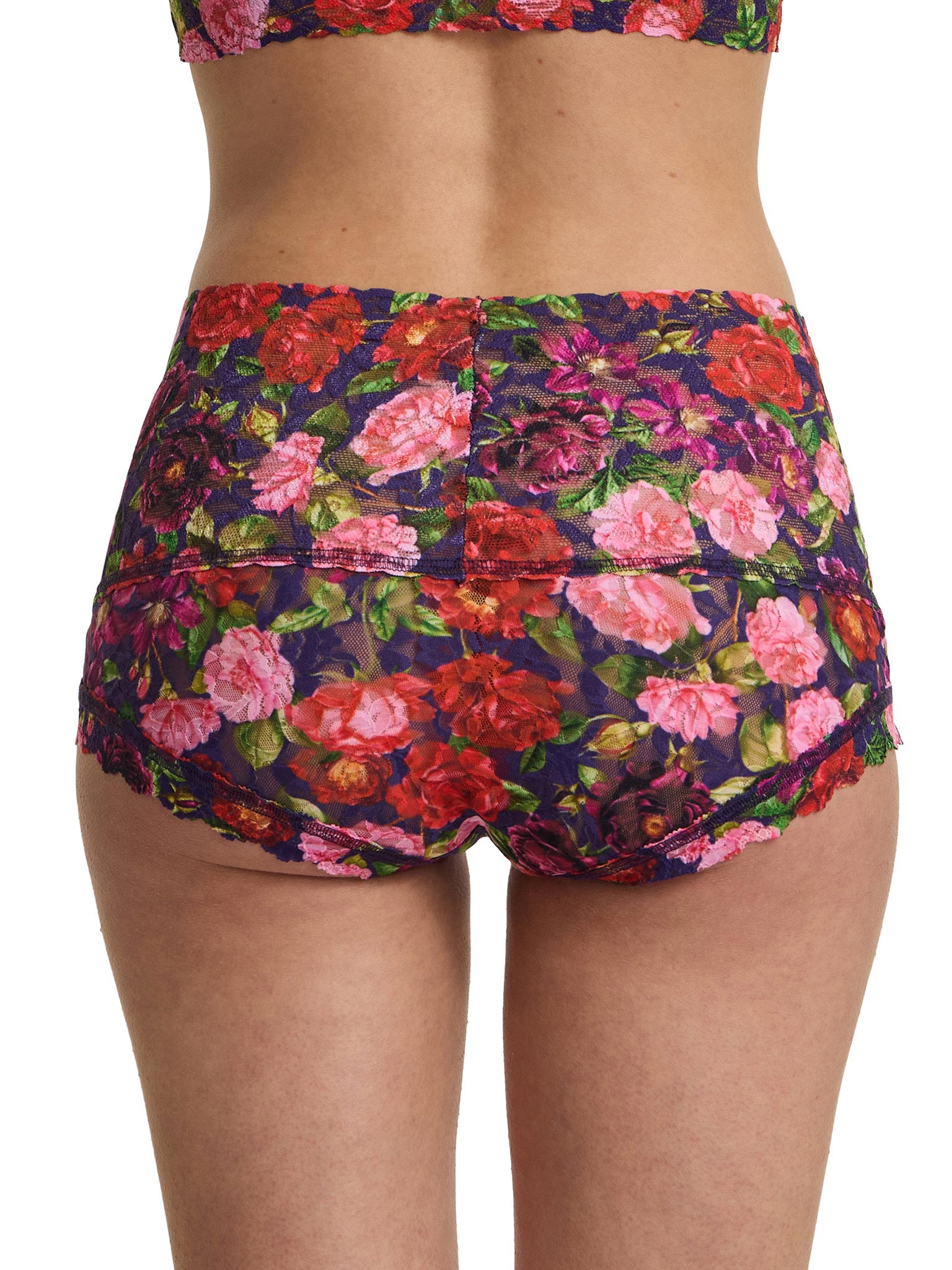 Floral patterned shorts worn by a person on a white background