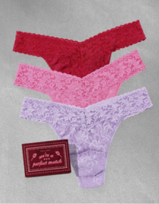 Three pairs of lace underwear in red, pink, and purple with a label on a gray background.