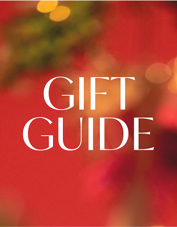 Gift guide text on a red background with blurred Christmas decorations