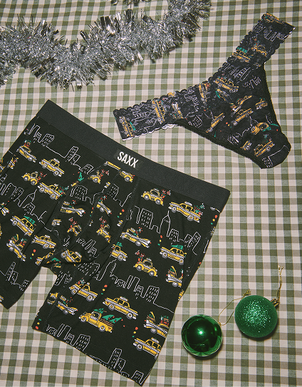 Saxx underwear with cityscape design on a checkered tablecloth with Christmas decorations.
