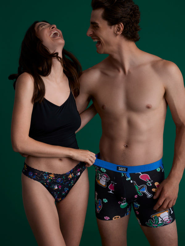 Man and woman wearing colorful underwear with a green background