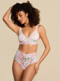 Woman wearing a floral bikini set on a beige background